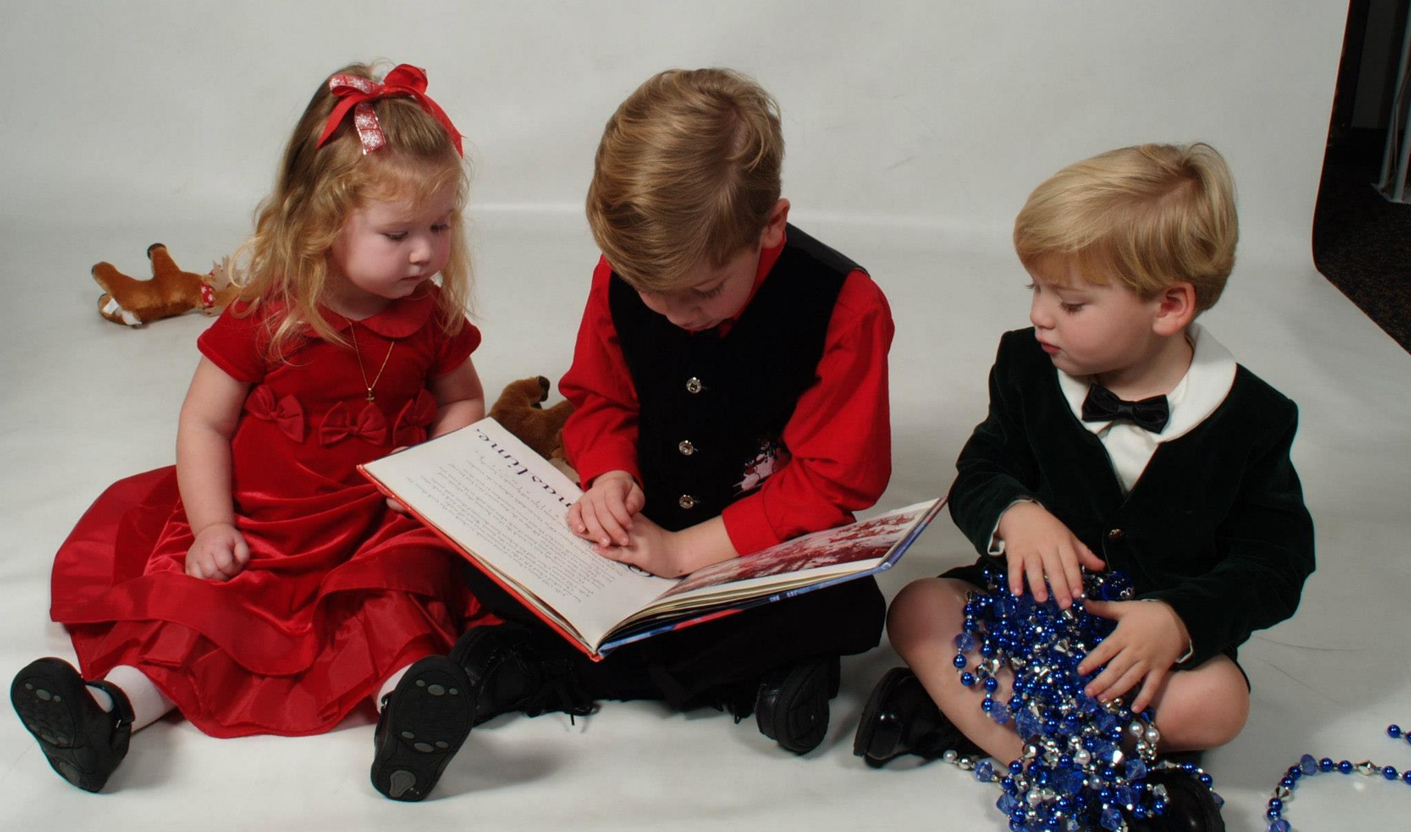 3 Kids Reading A Book